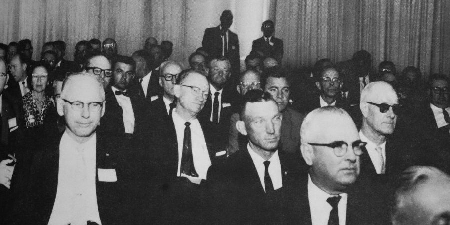 Archived black & white photo of TASB board members in a meeting