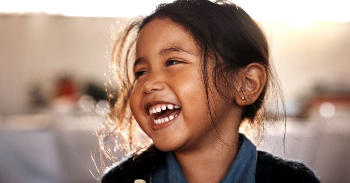 Young girl with brown hair smiling