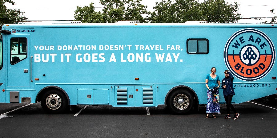 TASB employees smiling during mobile blood drive event.