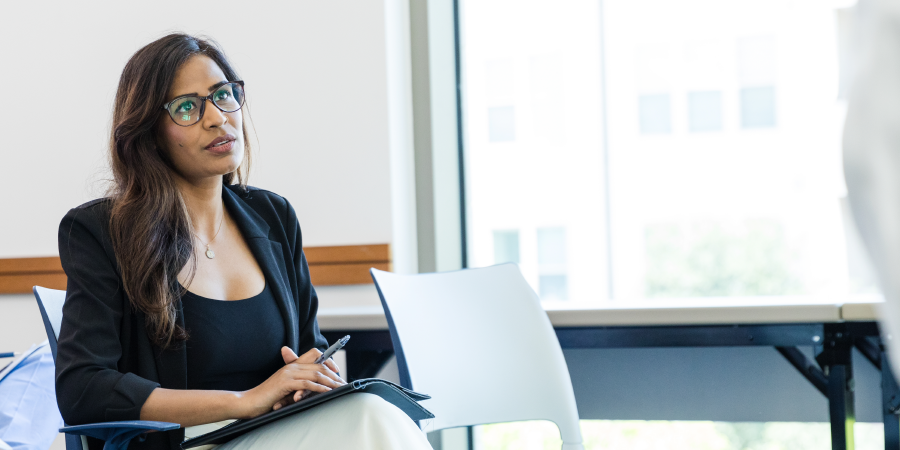 Woman sitting and listening in meeting